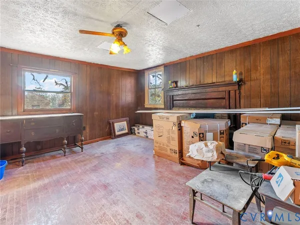 a living room with furniture gym equipment and view of kitchen