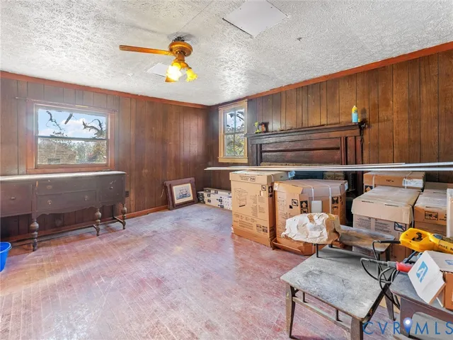 a living room with furniture gym equipment and view of kitchen