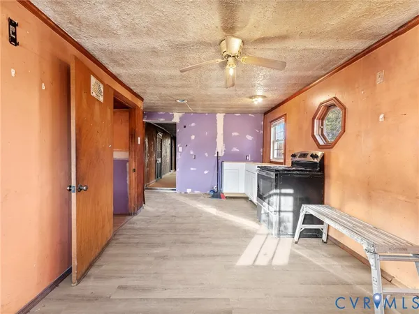 a view of a hallway with wooden floor and furniture