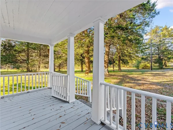 a view of a room with wooden floor and fence