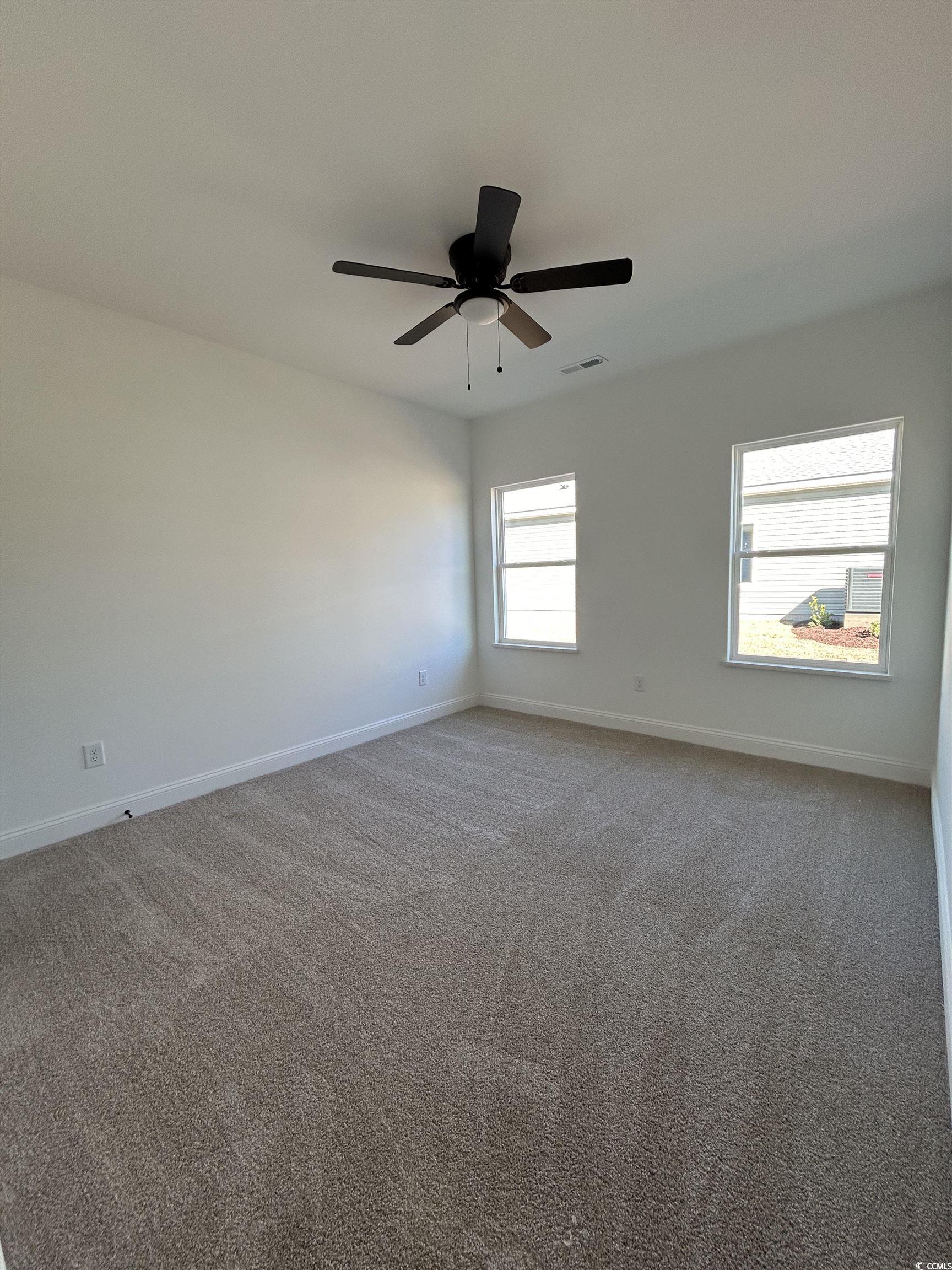 518 War Eagle Court Longs, SC 29568 - Photo 5 of 23 Empty room with ceiling fan and carpet flooring