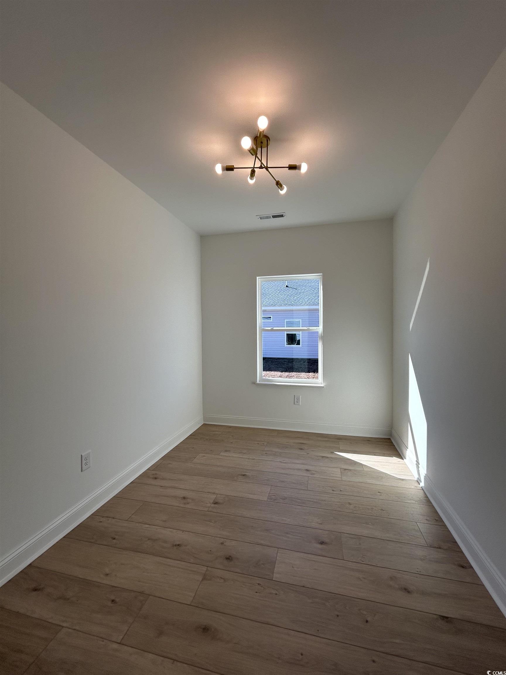 518 War Eagle Court Longs, SC 29568 - Photo 8 of 23 Spare room with a notable chandelier and light woo