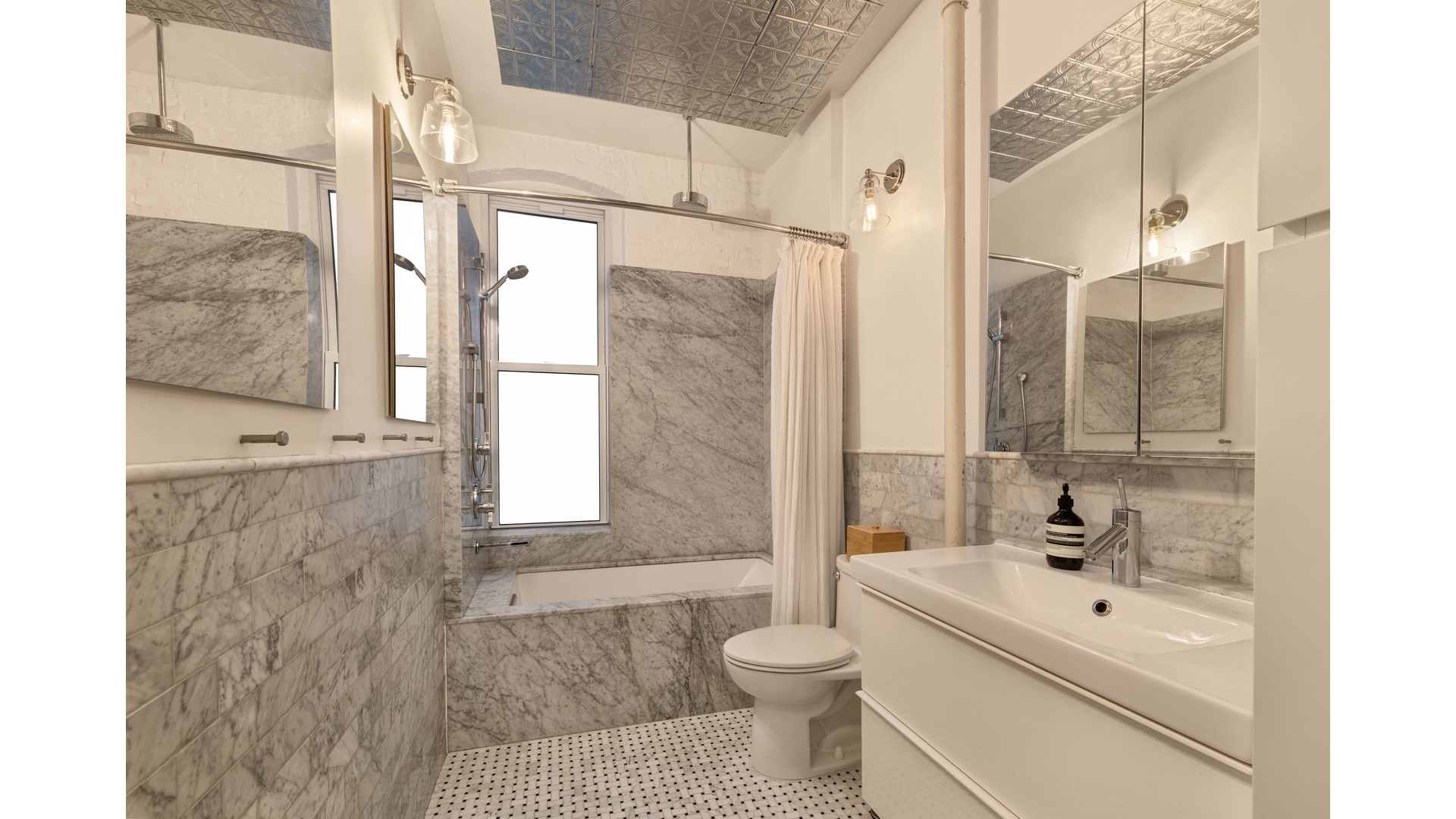 396 3rd Street, Unit SIX Brooklyn, NY 11215 - Photo 9 of 11 a bathroom with a bathtub shower sink mirror and toilet