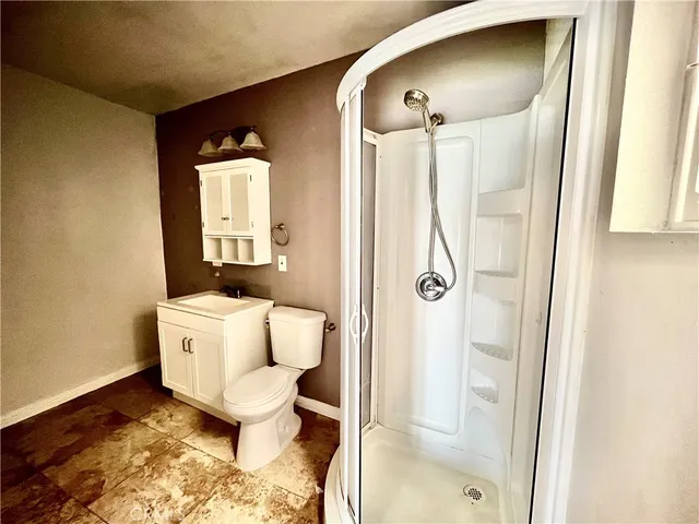 a bathroom with a toilet and a shower
