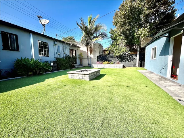 a view of a house with pool and a yard