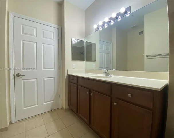 a bathroom with a double vanity sink and a mirror