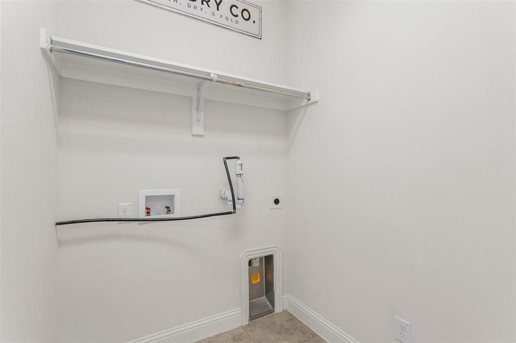 15713 Canyon Ridge Prosper, TX 75078 - Photo 10 of 38 Utility room featuring light-toned tile flooring, white baseboards, and a white overhead shelf with a hanging rod