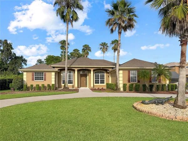 a front view of a house with a garden and yard