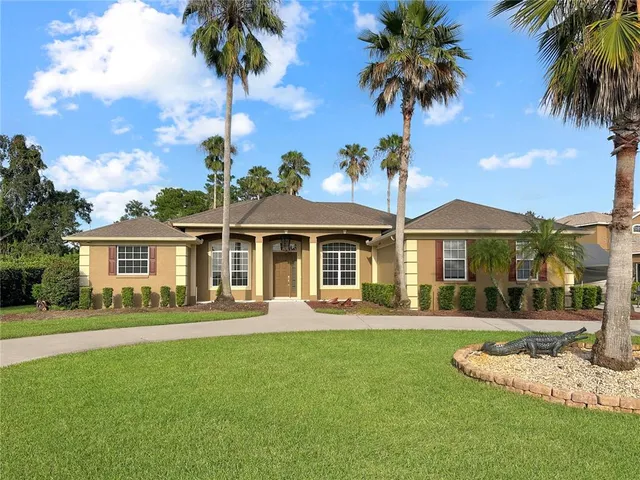 a front view of a house with a garden and yard