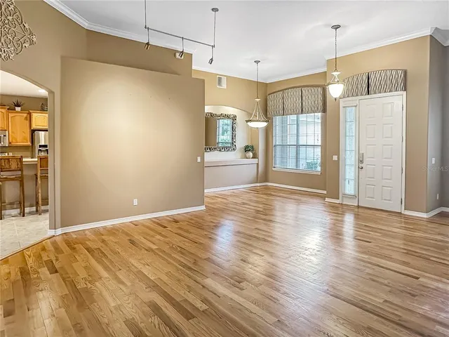 a view of a kitchen with wooden floor and a window