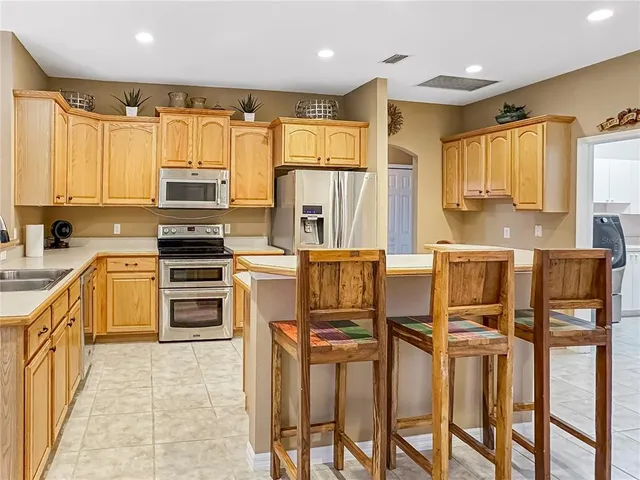 a kitchen with stainless steel appliances a refrigerator sink and cabinets