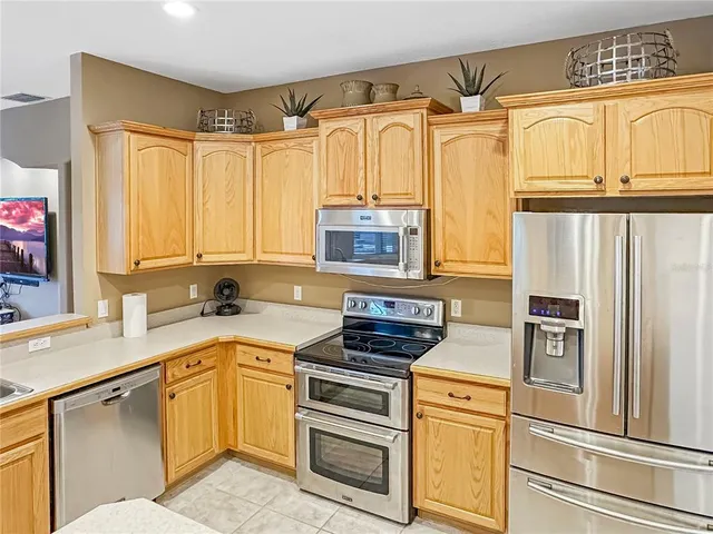 a kitchen with stainless steel appliances a stove sink and cabinets