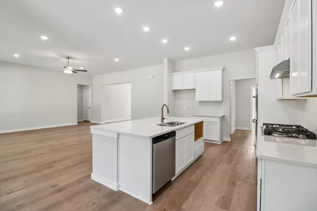 a kitchen with stainless steel appliances a sink stove and refrigerator