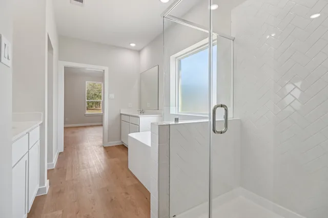 a bathroom with a granite countertop sink a toilet and shower