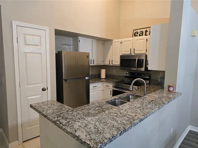 a kitchen with a refrigerator and a sink