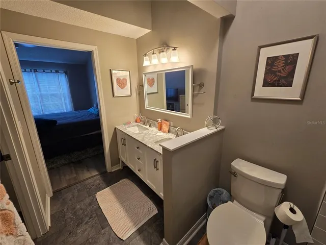 a bathroom with a toilet sink and mirror
