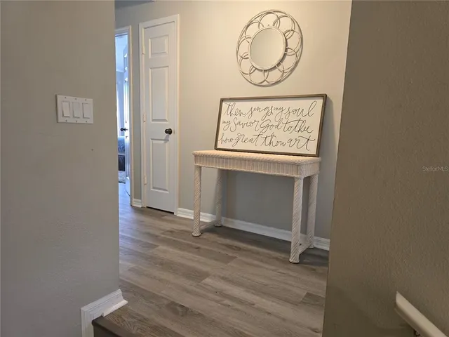 a view of front door with wooden floor