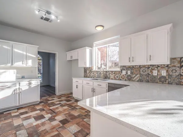 a kitchen with stainless steel appliances granite countertop a sink and cabinets