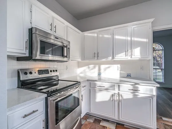a kitchen with appliances cabinets and a sink
