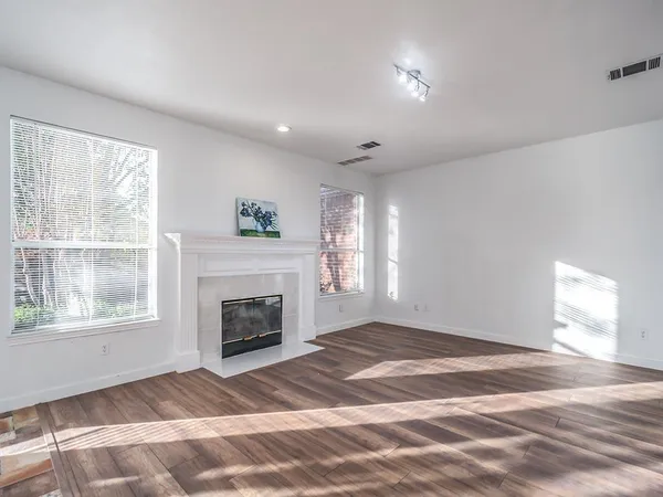 a view of empty room with a fireplace