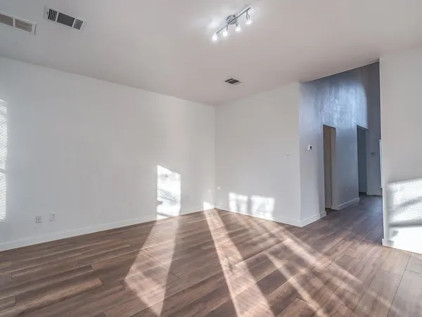 a view of a hallway with wooden floor