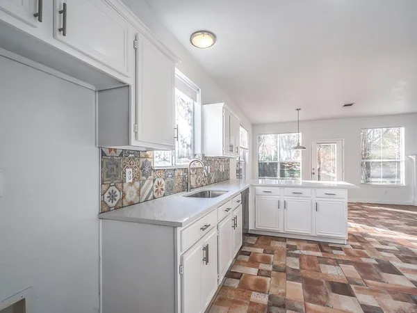 a kitchen with a sink stove and cabinets