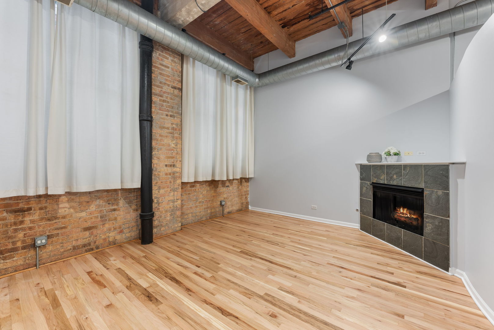 215 North Aberdeen Street, Unit 202B Chicago, IL 60607 - Photo 7 of 16 a view of empty room with wooden floor and fan