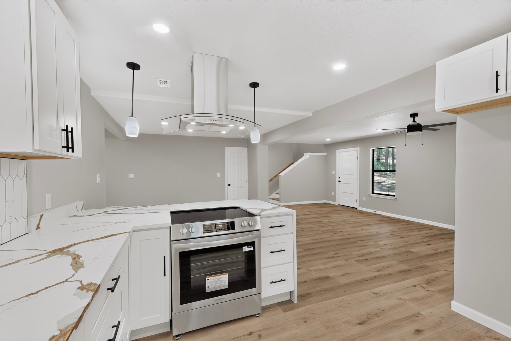 158 Fealy Road Red Rock, TX 78662 - Photo 14 of 40 An open-concept layout connects the modern kitchen seamlessly to the spacious living area.