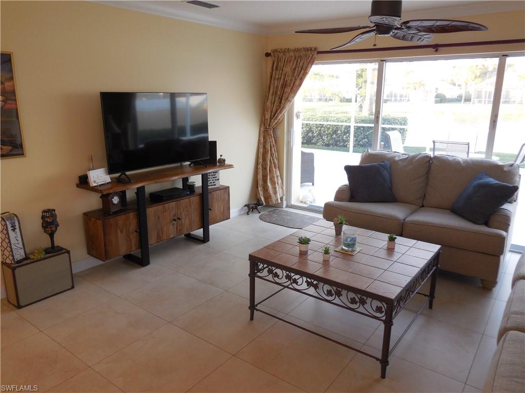 3703 Exuma Way Naples, FL 34119 - Photo 11 of 47 a living room with furniture and a flat screen tv