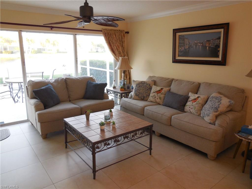 3703 Exuma Way Naples, FL 34119 - Photo 12 of 47 a living room with furniture and a large window