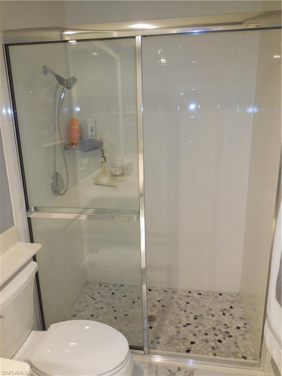 3703 Exuma Way Naples, FL 34119 - Photo 18 of 47 a bathroom with a shower a toilet and sink