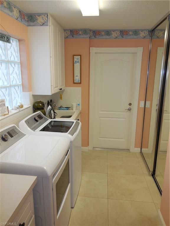 3703 Exuma Way Naples, FL 34119 - Photo 23 of 47 a kitchen with a sink a stove and a refrigerator