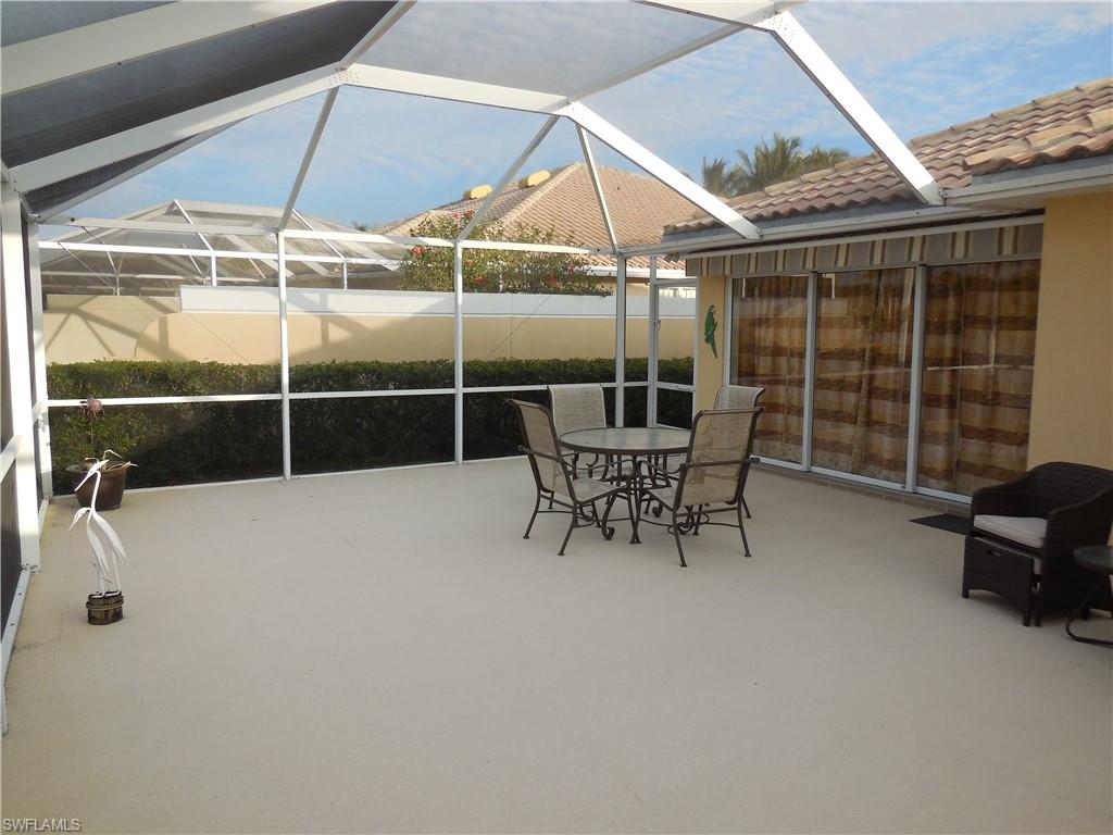 3703 Exuma Way Naples, FL 34119 - Photo 29 of 47 a outdoor space with a large window and sitting area
