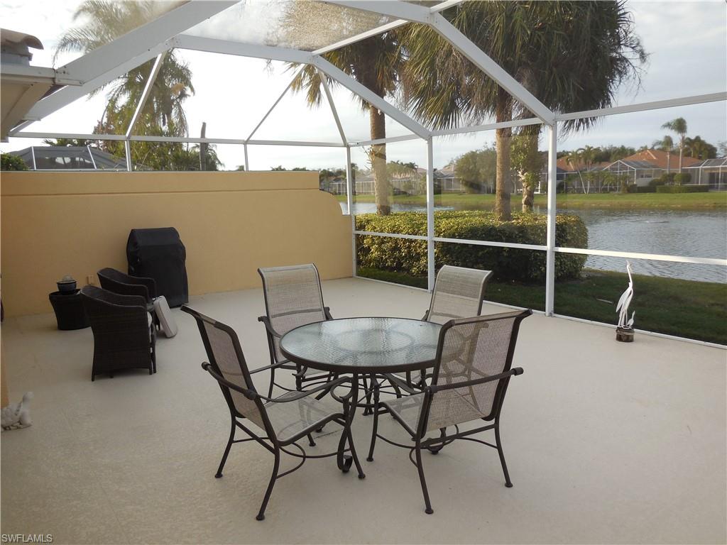 3703 Exuma Way Naples, FL 34119 - Photo 30 of 47 a balcony with table and chairs