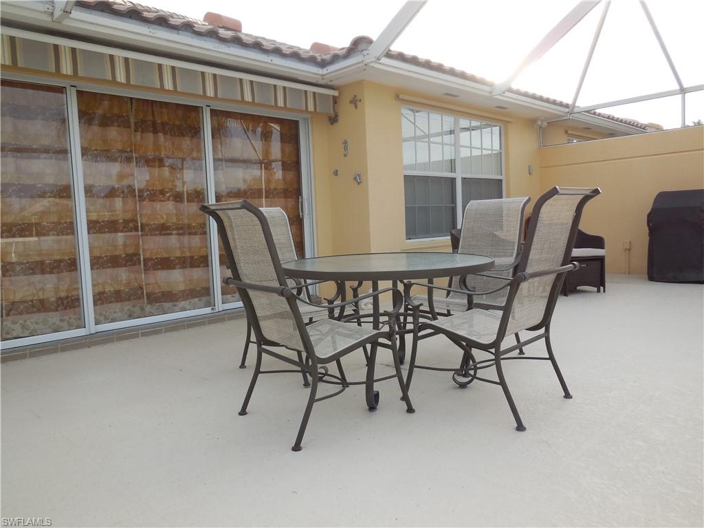 3703 Exuma Way Naples, FL 34119 - Photo 31 of 47 a view of a patio with table and chairs