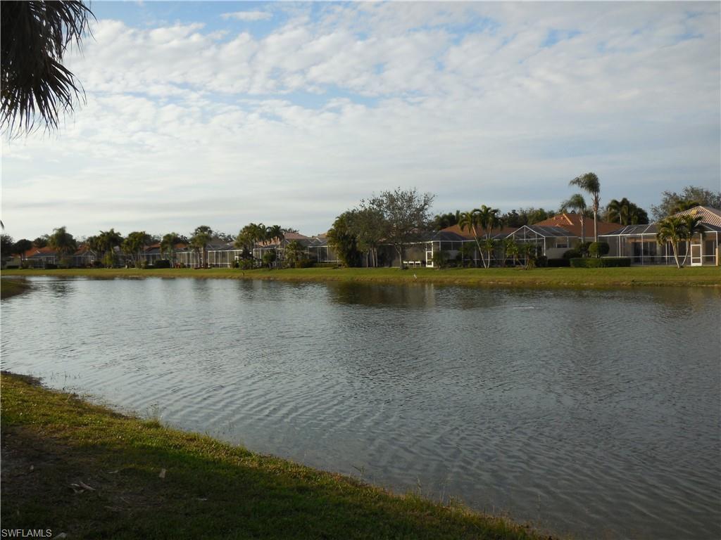 3703 Exuma Way Naples, FL 34119 - Photo 34 of 47 a view of a lake with houses in the back