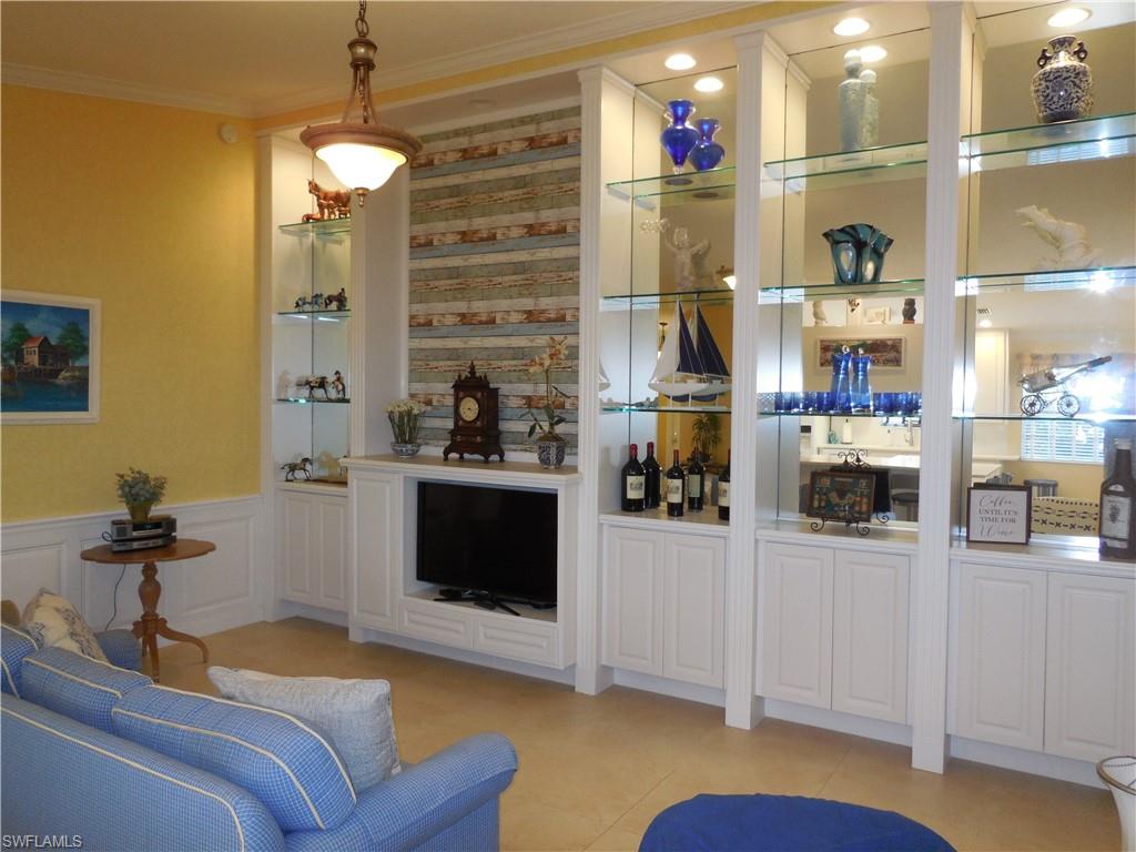 3703 Exuma Way Naples, FL 34119 - Photo 4 of 47 a living room with furniture and a fireplace