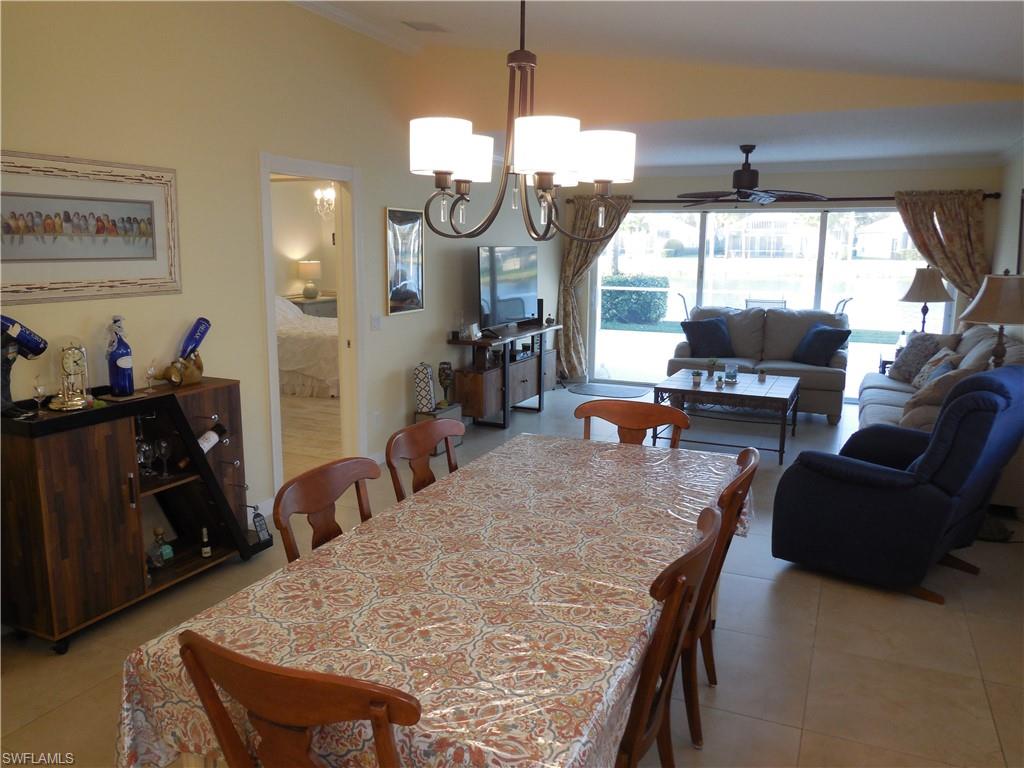 3703 Exuma Way Naples, FL 34119 - Photo 10 of 47 a dining room with furniture and wooden floor