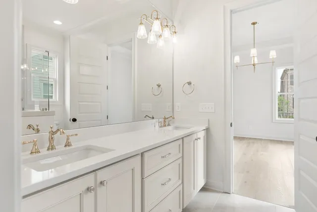 a bathroom with a sink double vanity and shower