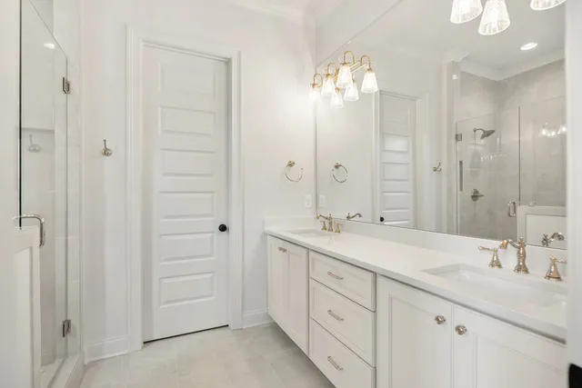 a spacious bathroom with a double vanity sink mirror and shower