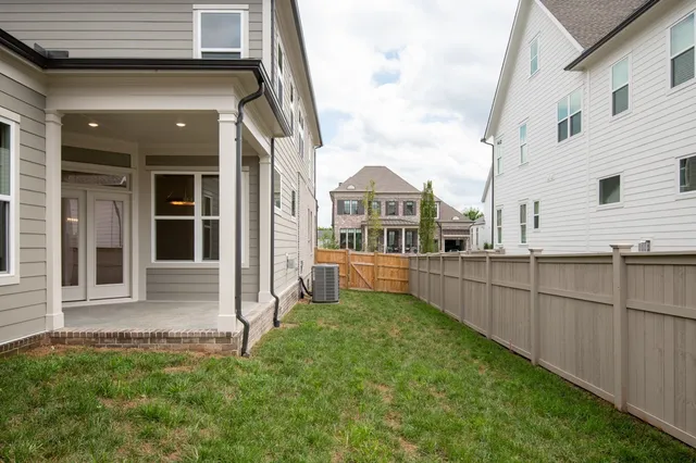 a view of a house with backyard and porch