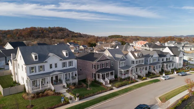 an aerial view of residential houses with city street