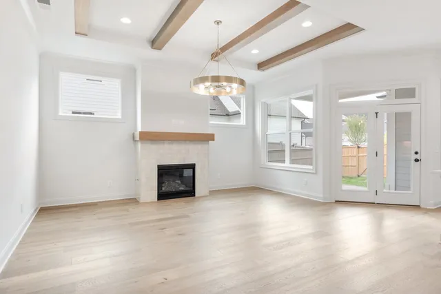 a view of a livingroom with a fireplace and window