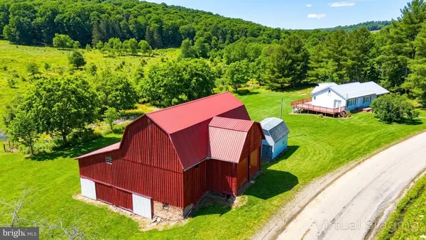 a view of backyard with deck and garden