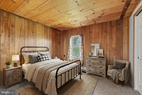 a bedroom with a bed a couch and dresser