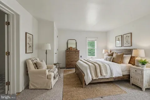 a spacious bedroom with a bed and a couch
