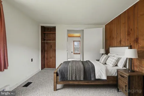 a bedroom with a bed and a night stand
