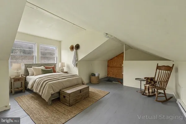 a bedroom with a bed chair and window