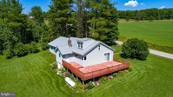 a aerial view of a house with a yard table and chairs