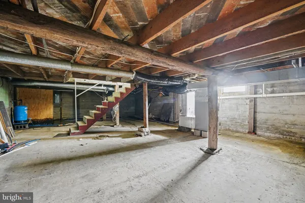 a view of a garage with wooden table and chairs